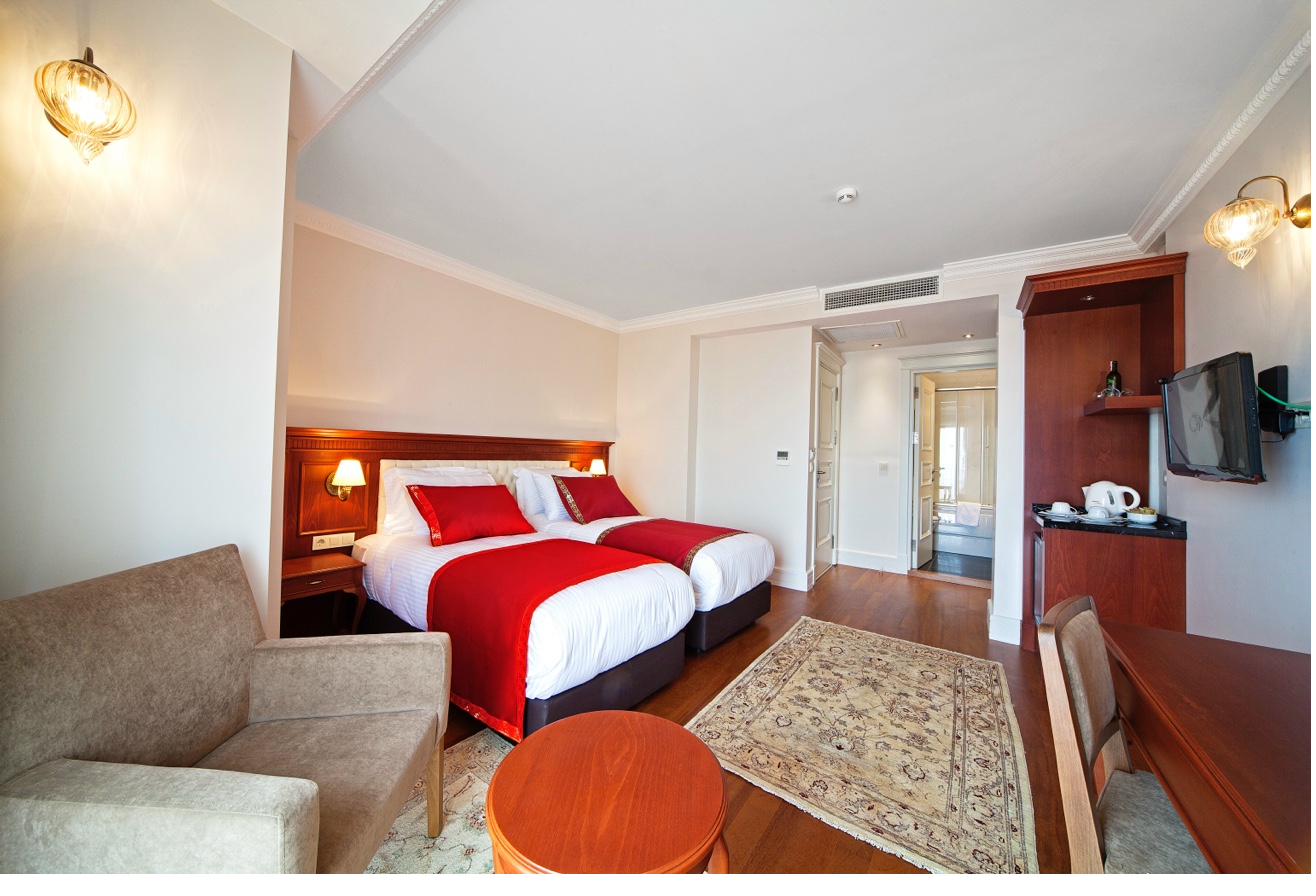 Superior Double Room with twin beds and warm lighting