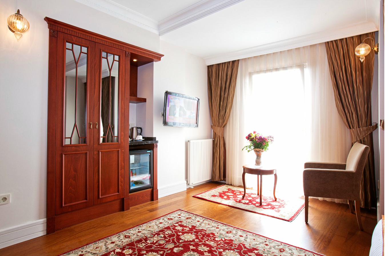 Superior Triple Room with desk and window view