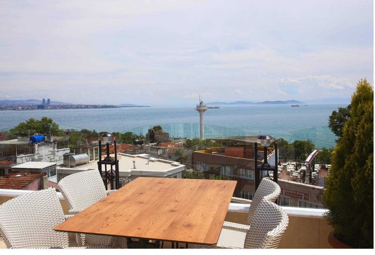 Rooftop terrace dining setup with Marmara Sea backdrop