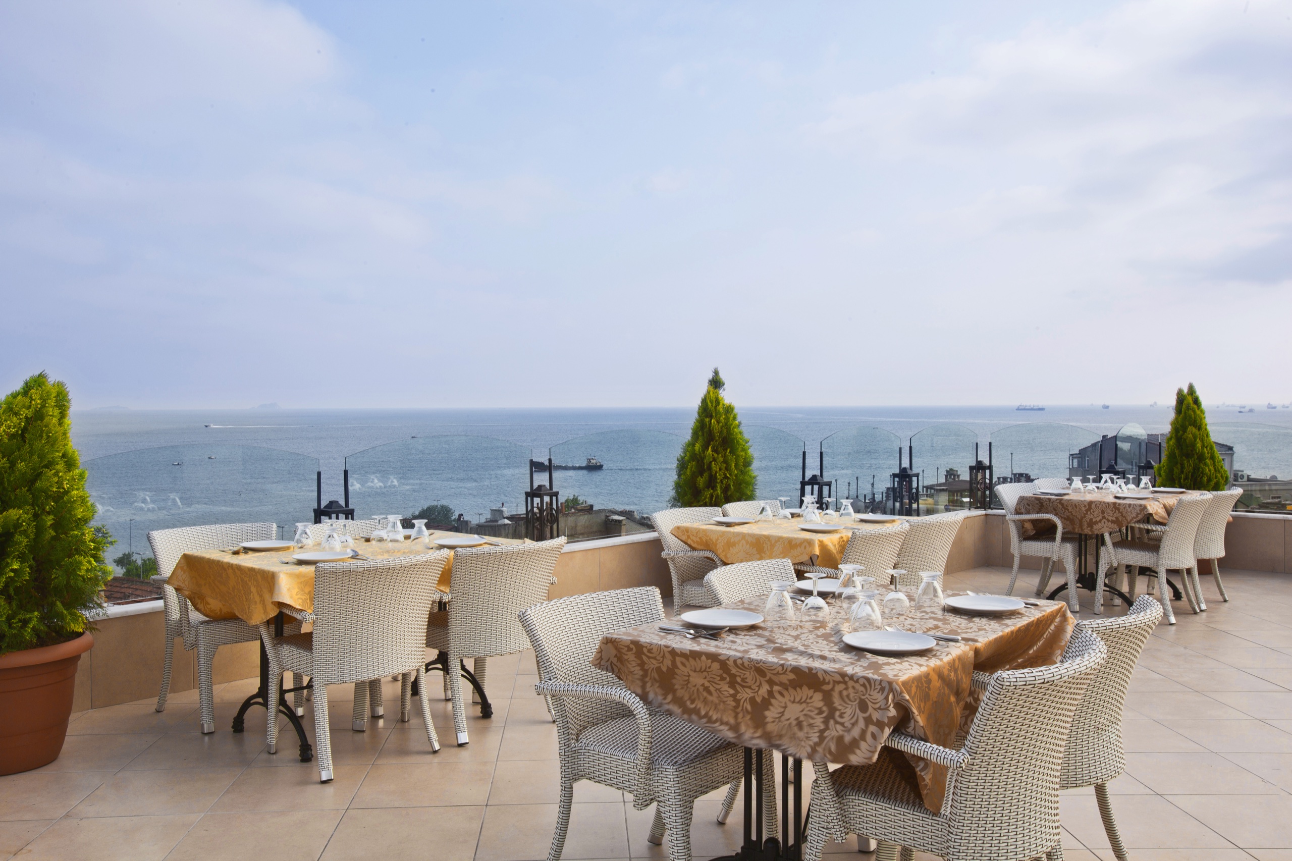 Prepared dining tables on the Aren Suites rooftop terrace